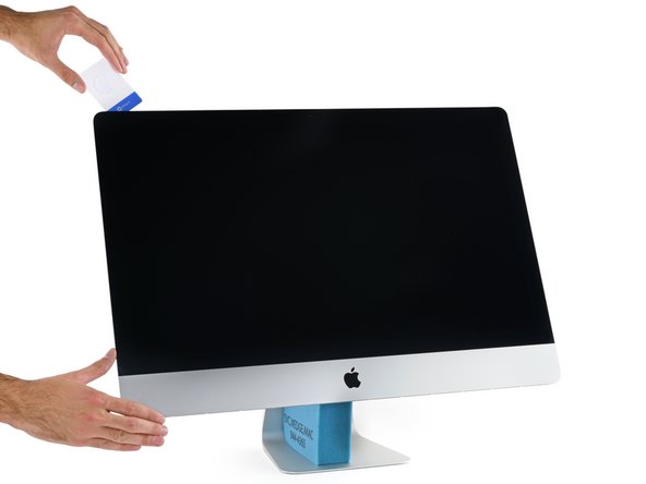 Image 2/3: With the adhesive tape gone, we get our first peek at the hardware inside the Retina 5K iMac.