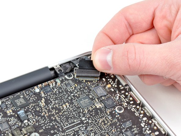 Image 2/3: Do not lift up on the display data cable, as its socket is very fragile. Pull the cable parallel to the face of the logic board.