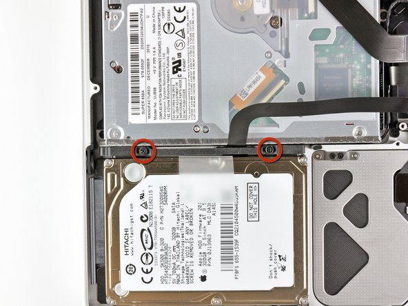 Image 1/2: These screws will remain captive to the hard drive bracket.