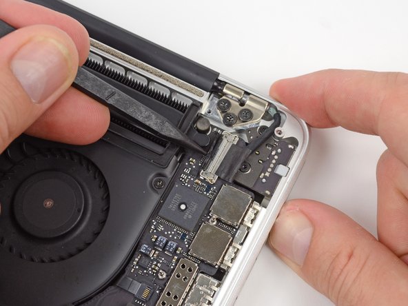 Image 1/3: Pull the display data cable straight out of its socket on the logic board.