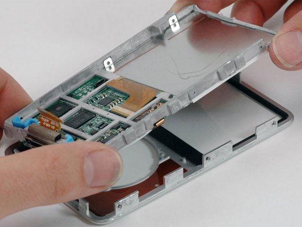 Image 1/1: Make sure that the click wheel button is in place before reinstalling the framework in the front panel.