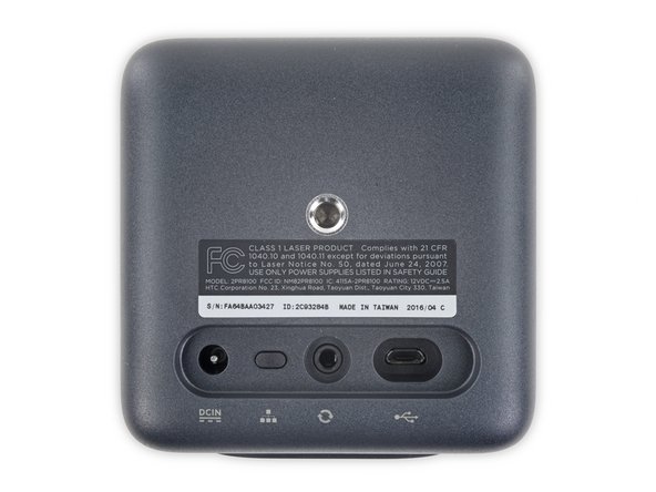 Image 1/3: The base station sports the model number [https://fccid.io/NM82PR8100|2PR8100|new_window=true] as well as a Class 1 Laser Product regulatory label.