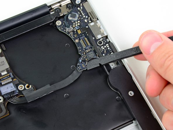 Image 2/2: Pry up from beneath the wires.