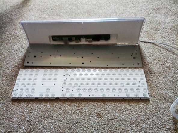 Image 1/3: Gently place the white key holder to one side, don't tip it or you could lose some of the key nodules.