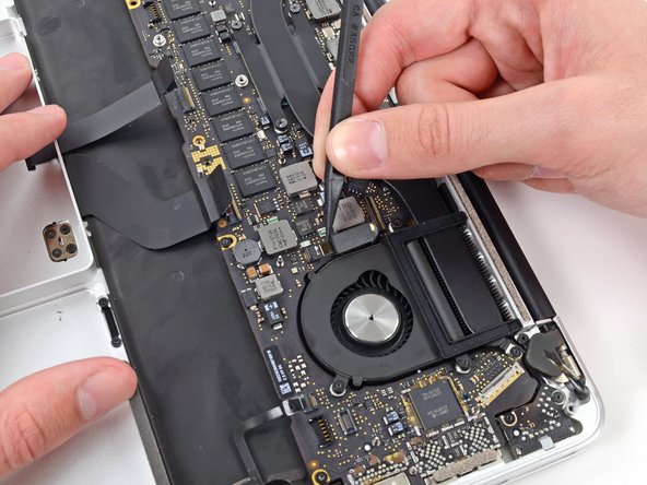 Image 3/3: Carefully pull the left fan ribbon cable out of its socket.