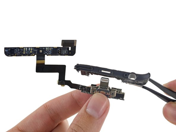 Image 2/3: The two Lightning connectors are housed on the same board, with its connecting cable wrapped around a plastic frame.