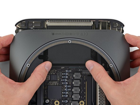Push firmly in the direction of the ports until the logic board unclips and begins to slide out of the Mac mini.