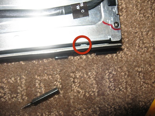 Image 1/3: Use a flat blade driver or metal spudger to Gently pop the bezel off the lock tabs.