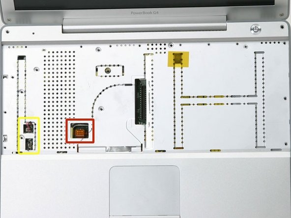 Image 1/1: Peel up the two pieces of foil tape on the left side of the keyboard area.