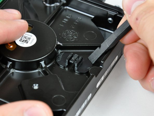 Image 1/1: If you're replacing your hard drive, transfer this bracket and the thermal sensor to your new hard drive. If the adhesive refuses to stick during reinstallation, apply double-sided tape to the underside of the two flat ears of the thermal sensor bracket.