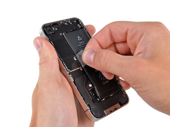 Use the clear plastic pull tab to gently lift the battery out of the iPhone.