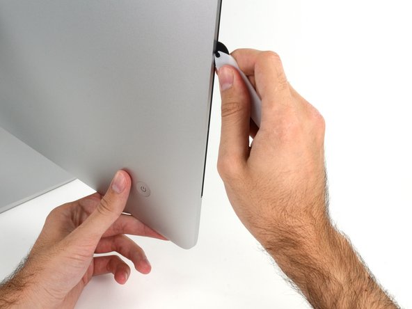 Image 3/3: Run the tool up along the left side of the display.