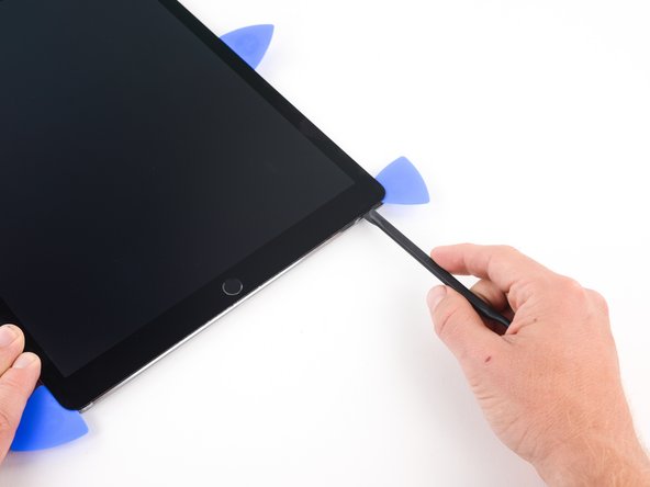 Insert the blade of a halberd spudger to the left of the opening pick  on the bottom right corner of the iPad.