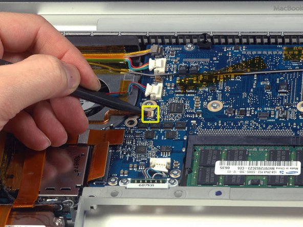 Image 1/1: Slide the left ambient light sensor cable to the left and out of its connector.