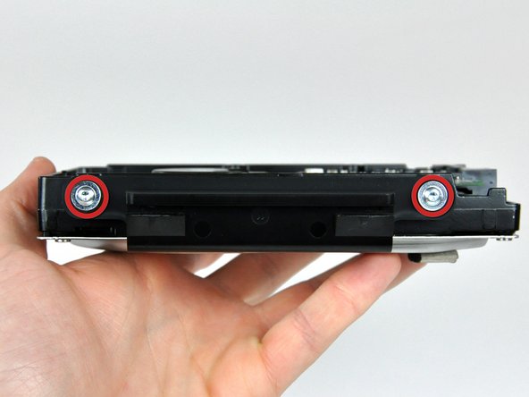 Image 1/1: After you remove these two screws, the hard drive bracket will fall away from the hard drive.