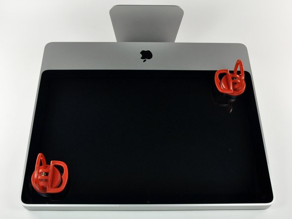 Image 1/2: Stick two suction cups to opposing corners of the glass panel.