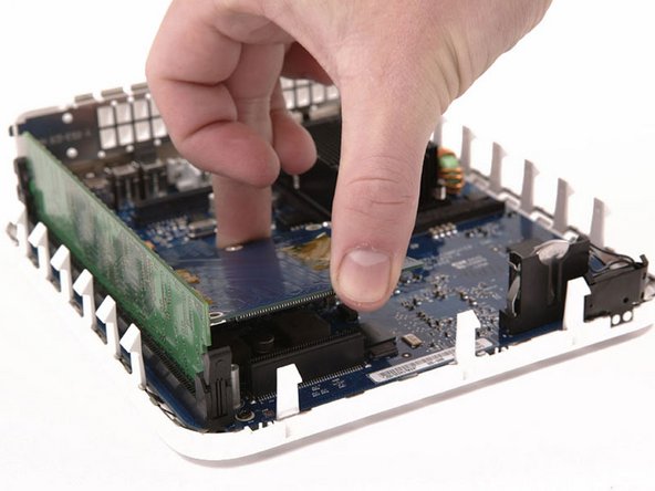 Grasp the board at the front and back, and lift up on the front until the board pulls free of its connector.