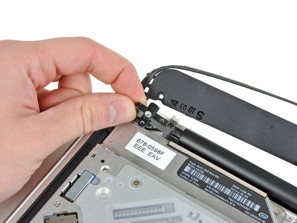 Image 2/2: Lift the camera cable bracket out of the upper case.