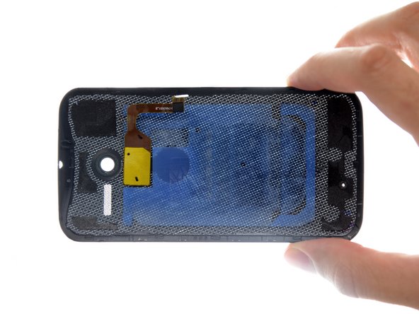 Image 3/3: Our guess is that the adhesive pad was added to make the phone feel more solid than one purely secured with clips. The pad also keeps the flash firmly in place, and may act as as padding to protect internal components.