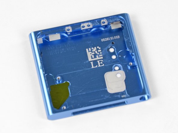 Recruiting the help of our spudger and our precision tweezer set, we remove the remaining gallons of glue from inside the nano's case.