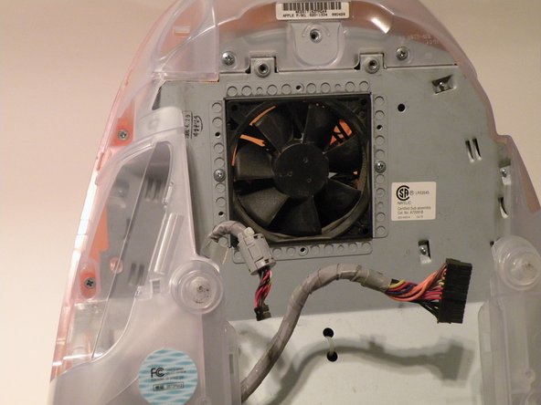 Image 3/3: Now, grab the logic board assembly by the piece of plastic, and lift it out.