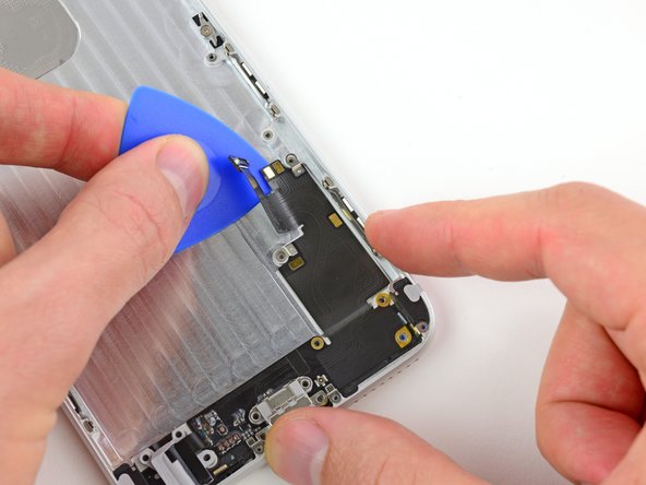 Image 1/3: Carefully work the pick down the right side of the Lightning connector and headphone jack cable, making sure to '''stop''' right as you hit the bottom.