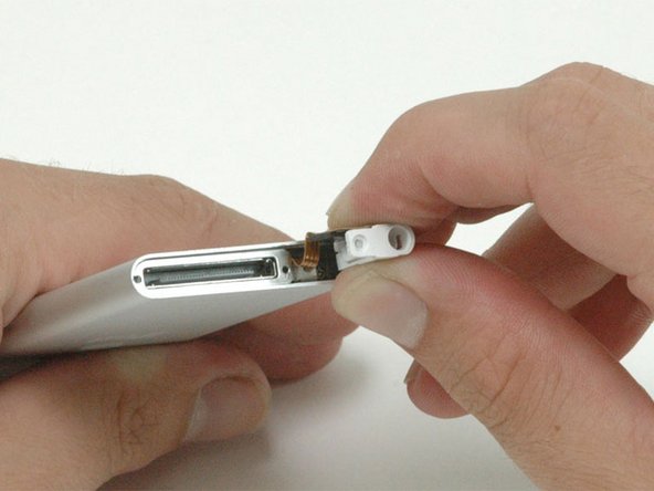 Slide the headphone jack out until the white plastic housing is no longer held in place by the metal casing.