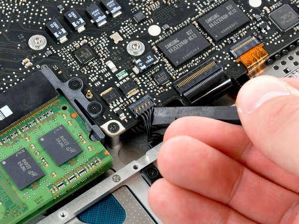 Image 1/1: Pry up under the cable wires to avoid pulling the socket itself off of the logic board.