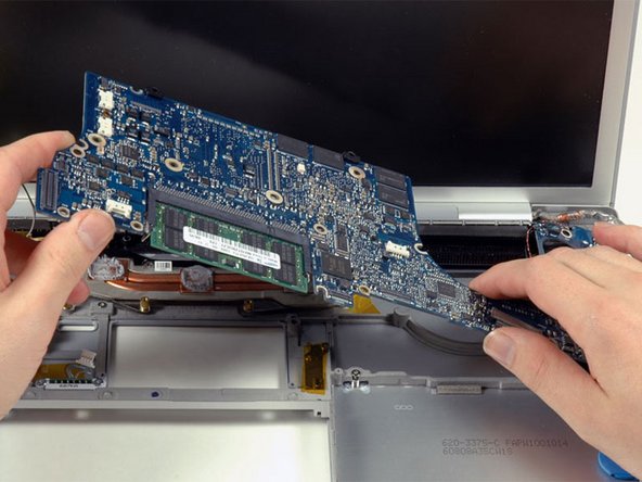 Image 1/1: Grasp the logic board at the left side and at the thin section, and rotate the logic board out of the lower case.