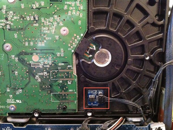 Image 3/3: Use a spudger to pry the thermal sensor and adhesive off the hard drive and install it in the same location on the replacement drive.