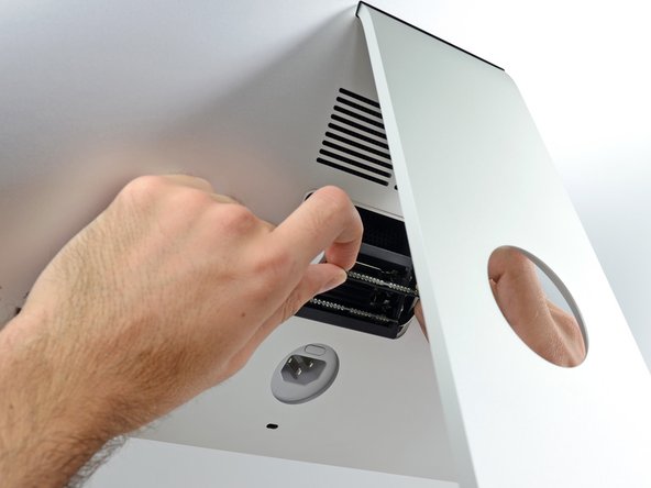 Image 2/3: To install a new module, insert the module into the desired slot in the tray and press it firmly in place. Push the tray back up until it locks in place.