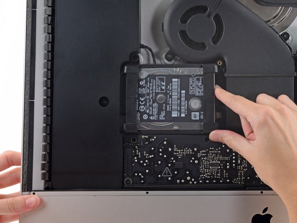 Image 1/3: The hard drive is attached by a single SATA power/data cable, do not attempt to fully remove it from the iMac.