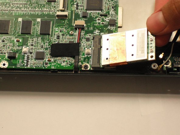 Gently pull the wireless card to the right and slide it out of its socket.
