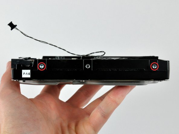 Remove the two T8 Torx pins from the side of the hard drive nearest the power and data connectors.