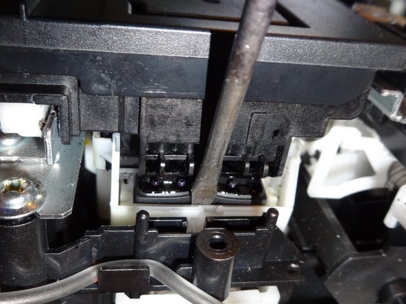 Slide the print head to the left freeing it to move