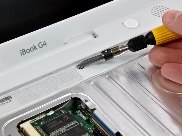 Image 1/1: Turn over the computer and open it.