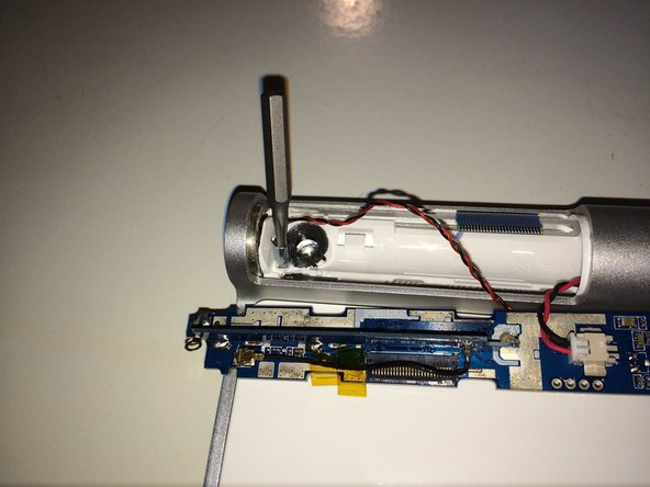 Image 1/3: Also, here is the battery terminal (spring loaded) which had to be forced out.  It's held in the tube by the expansion ring, which unfortunately is the best-made bit of this keyboard.  I forced it out using a long screw driver, but unfortunately broke the wires.  Keyboard had died anyway, thanks Apple.