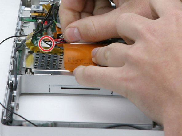 Image 1/1: Lift the speaker board up from the computer so that you can access and disconnect the speaker cable from the sound board.