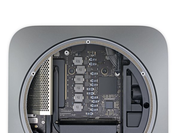 Use a T10 Torx driver to remove the two 7.5 mm screws securing the logic board.