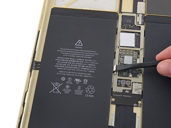 Image 2/3: At long last we've extracted the logic board—and its (sadly) soldered on Lightning connector.
