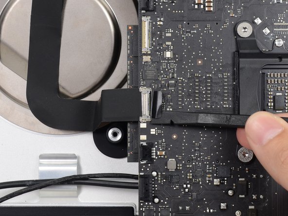 Image 1/3: Pull the iSight camera cable straight out of its socket on the logic board.