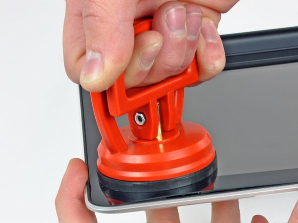 Image 3/3: Slowly and gently pull the corner of the display glass up off the display assembly.