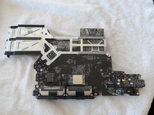 Image 1/3: Flipping the board over you'll find all the back-panel connectors and some nifty copper heat piping for the CPU and GPU.