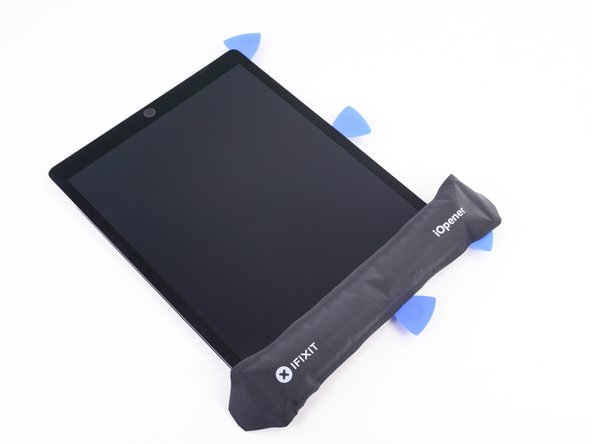 If necessary, reheat your iOpener and lay it over the top edge of the device. Wait a couple minutes for the adhesive to soften before reinserting the blade of the halberd spudger.