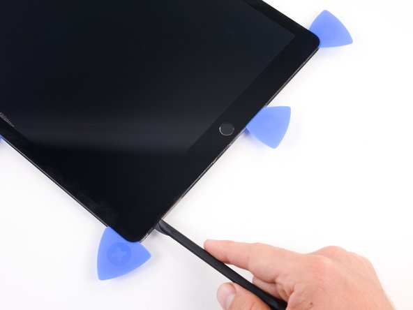 Continue sliding the blade along the edge until you reach the first opening pick you inserted.