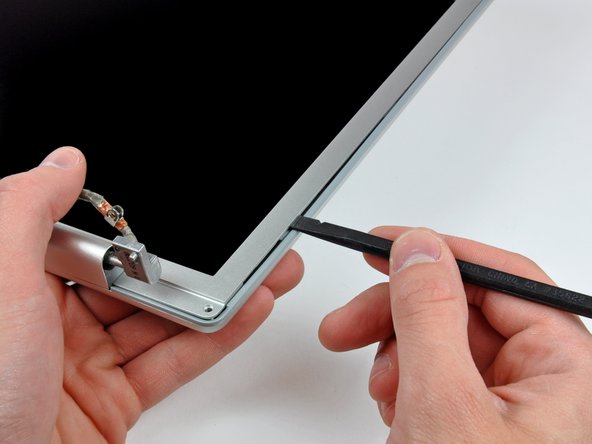 Image 2/3: Work along the right edge of the display until the rear bezel is evenly separated from the front bezel.