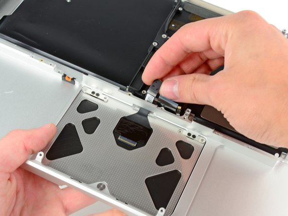 Image 2/2: Pull the trackpad cable as you seat the trackpad into its void in your new upper case.