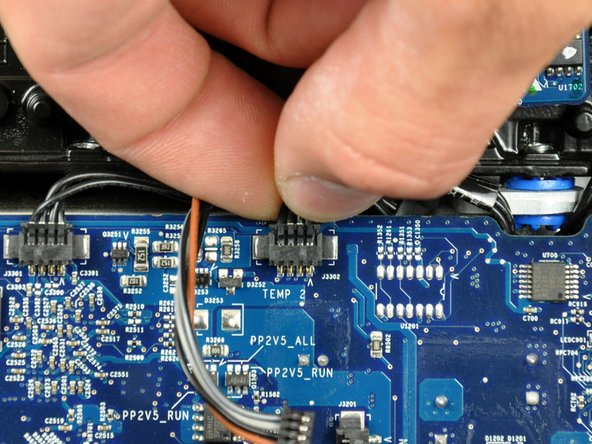 Image 2/2: Disconnect the optical drive temperature sensor connector from the logic board by pulling it straight away from its socket.