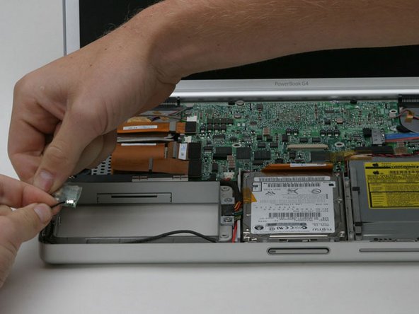 Image 1/1: Deroute the bluetooth antenna cable along the left edge of the computer, removing tape as necessary.