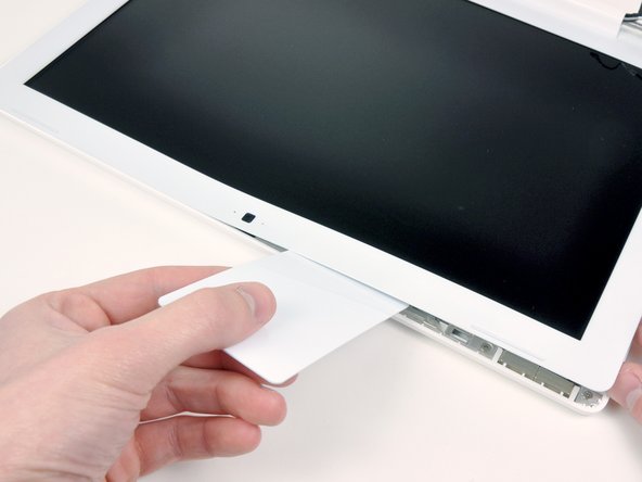 Continue to free the tabs along the the top edge of the display assembly.